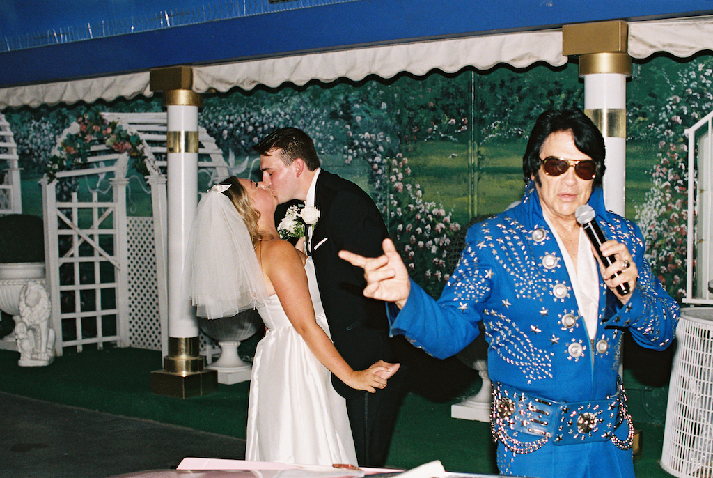 bride and groom kissing with elvis singing
