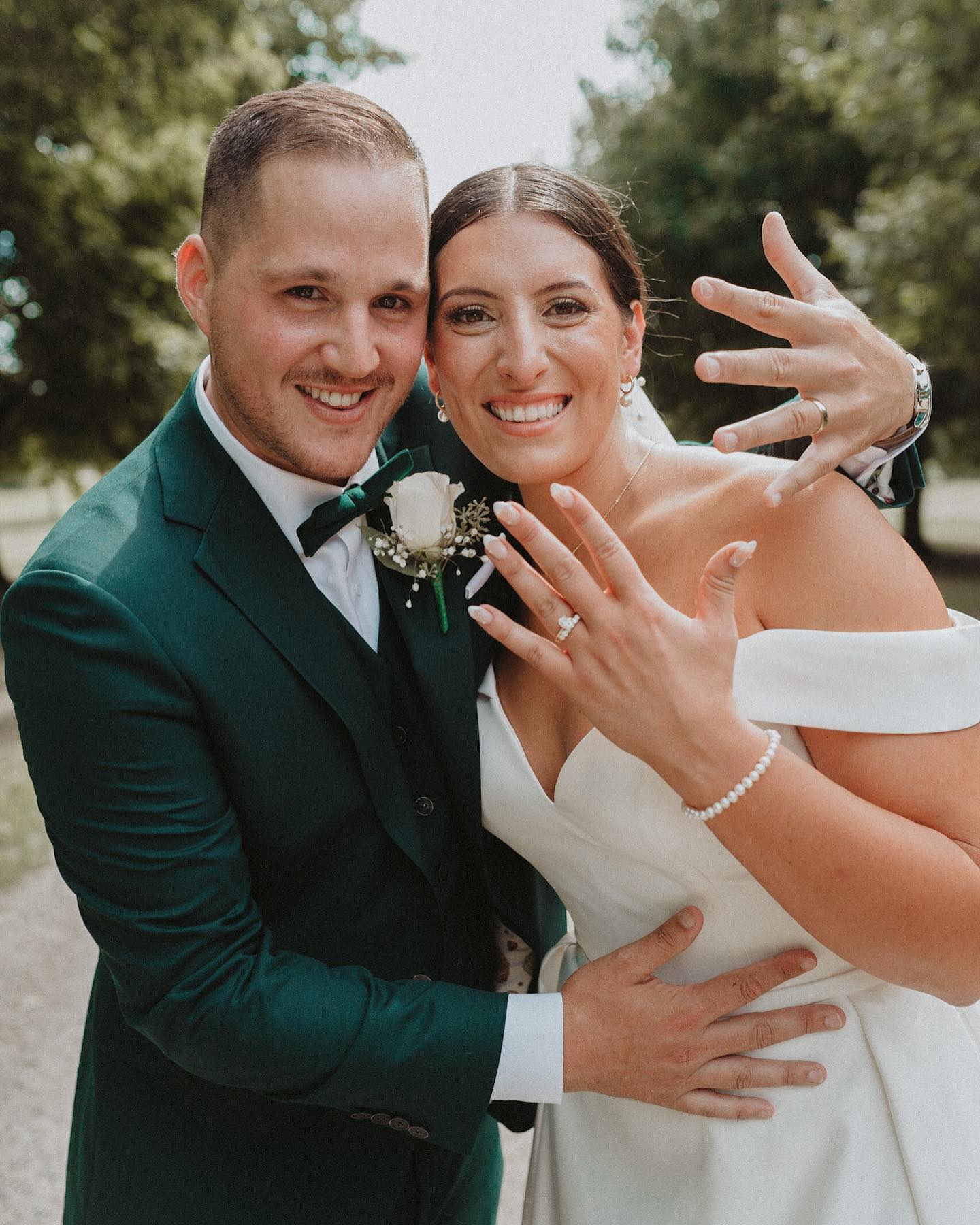bride and groom showing rings