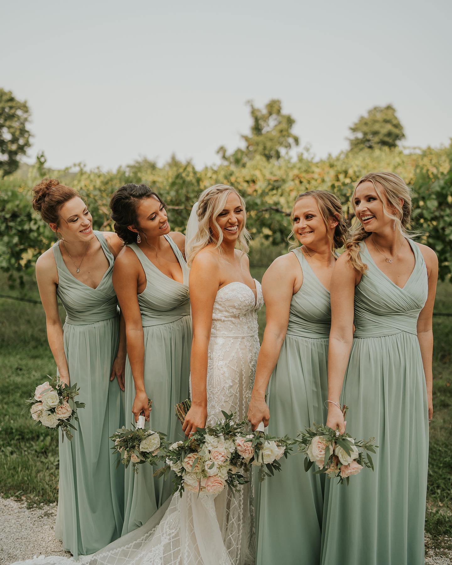group of bridesmaids wearing dusty sage dresses