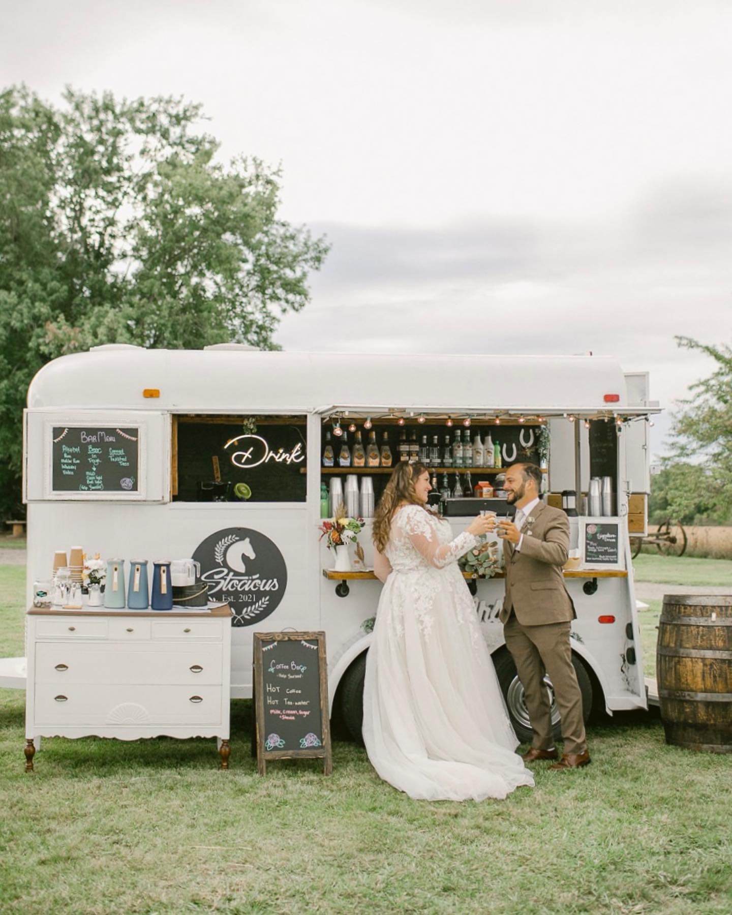 bride and groom cheers at mobile wedding bar