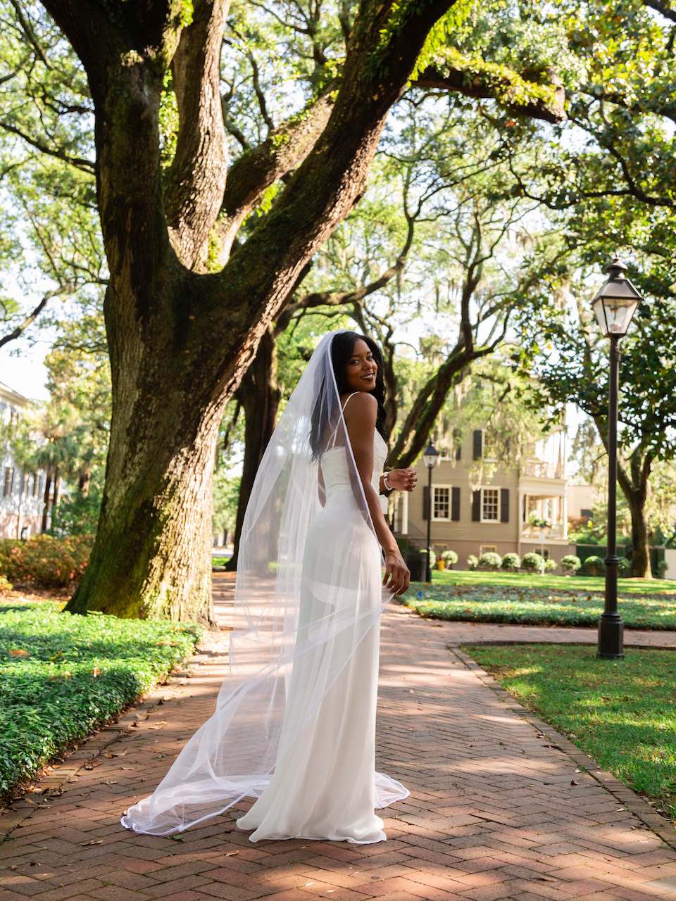bride in a white wedding dress with a long cathedral veil